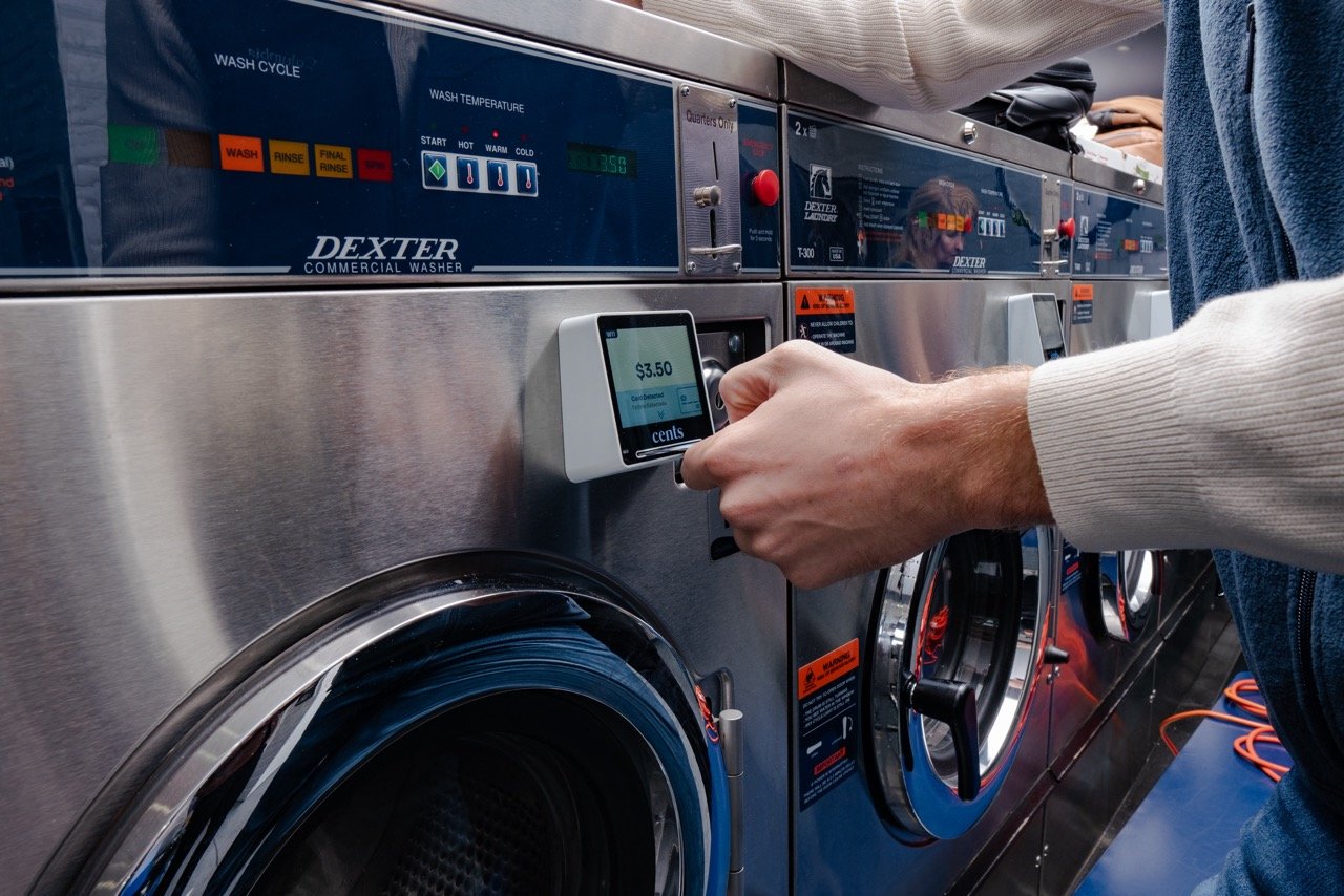 Customer-using-card-payment-through-penny-device-on-washer